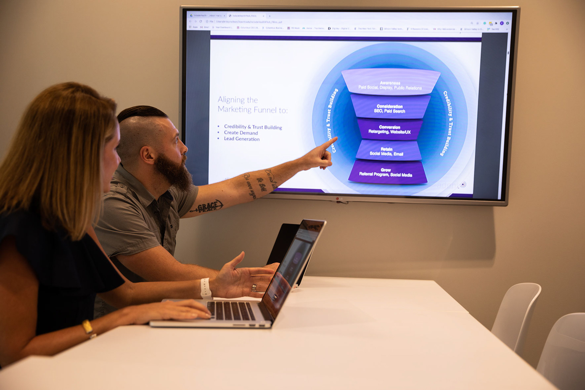 Upright team members working around conference room table