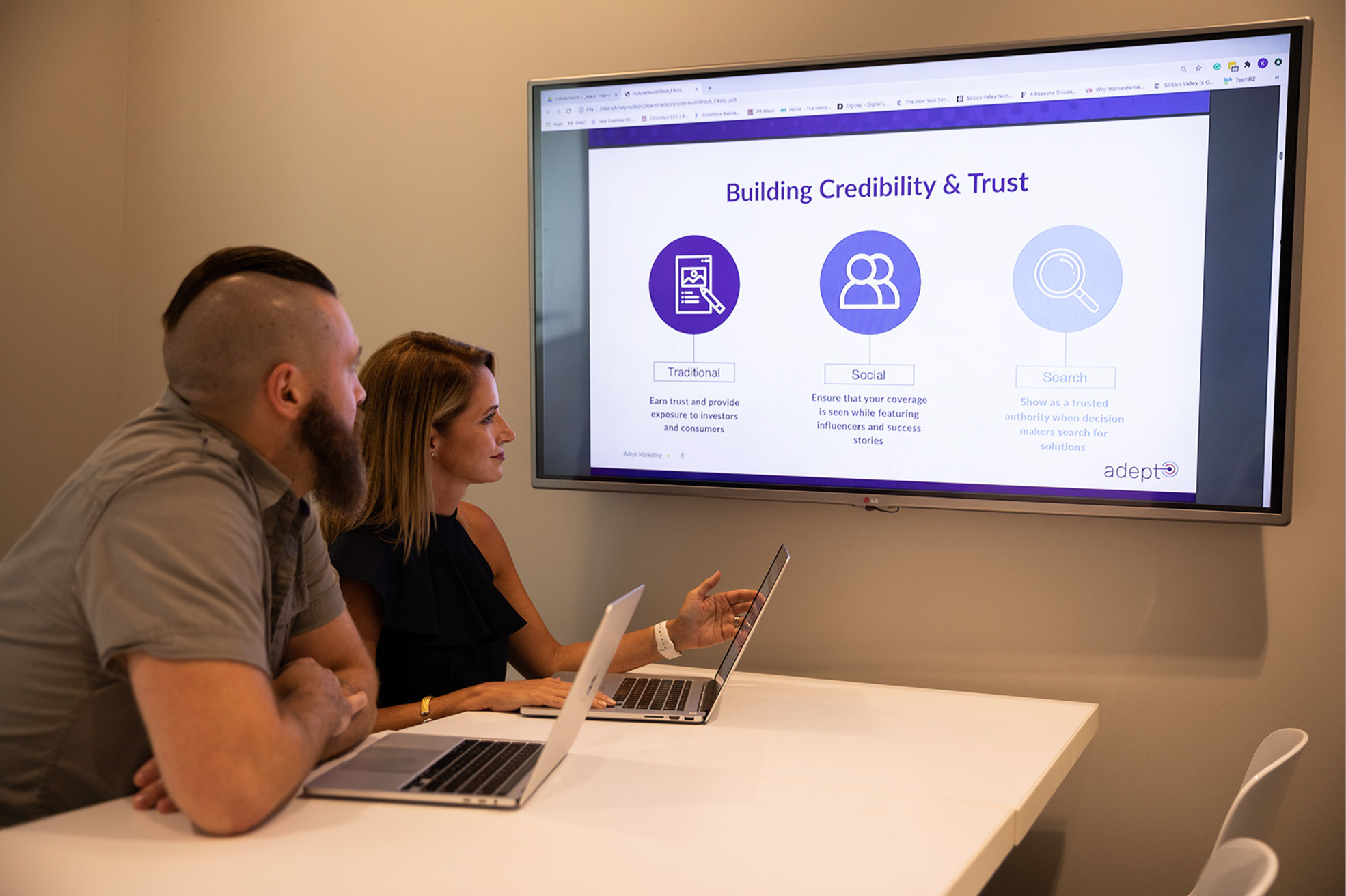 Upright team members working around conference room table